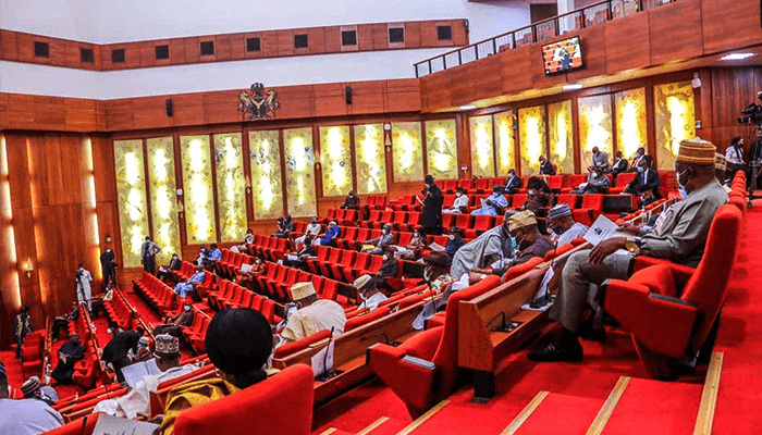 It Is Not Senator Yau - Nigerian Senate Debunks Viral Video Of Man Kissing A Woman In An Office
